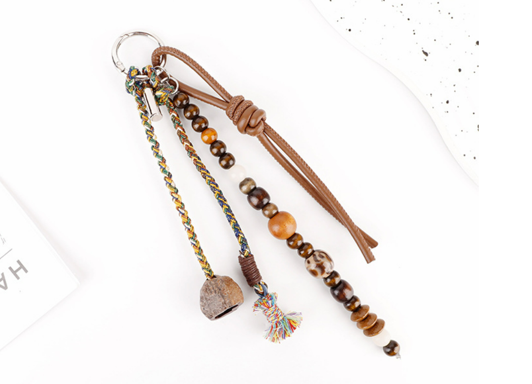 Woven charm attached to the handle of a tote