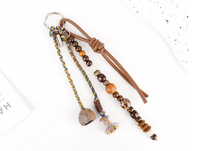 Woven charm attached to the handle of a tote