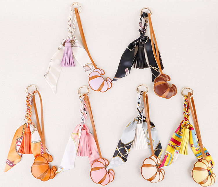 Croissant-inspired detail hanging beside a handbag handle