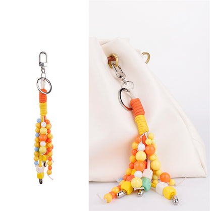 A colorful handmade accent clipped onto a travel bag