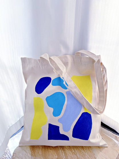 Canvas tote hanging on a chair in a soft natural light home interior setting