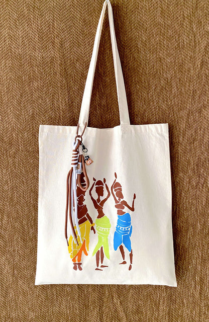 An oversized foldable bag being tucked into a small coat pocket.