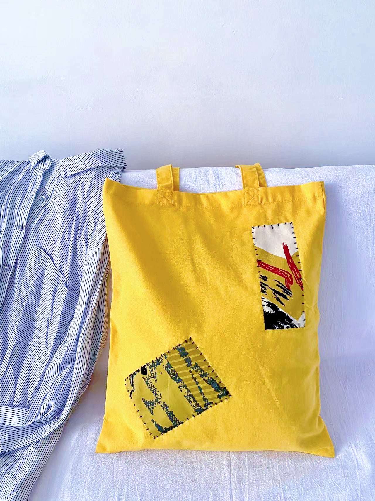 Authentic hand-sewn textile art on a simple functional grocery carrier