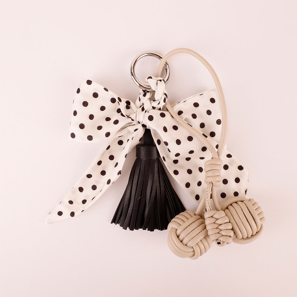 Handmade bow clip attached to a casual straw beach tote handle