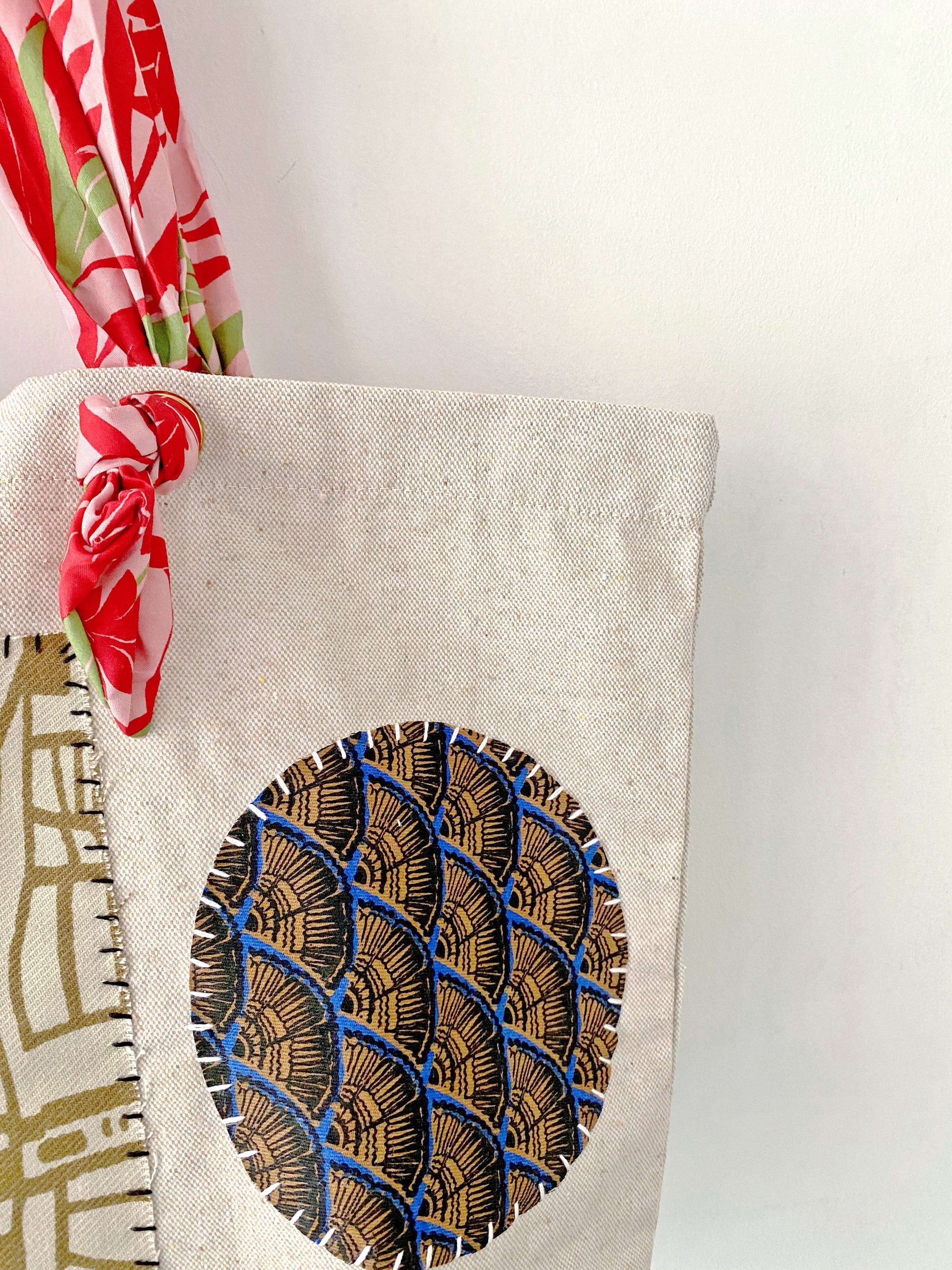 Foldable yet incredibly strong, this artisan-patched canvas bag fits perfectly under an airplane seat for a conscious traveler's weekend trip.