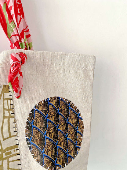 Foldable yet incredibly strong, this artisan-patched canvas bag fits perfectly under an airplane seat for a conscious traveler's weekend trip.