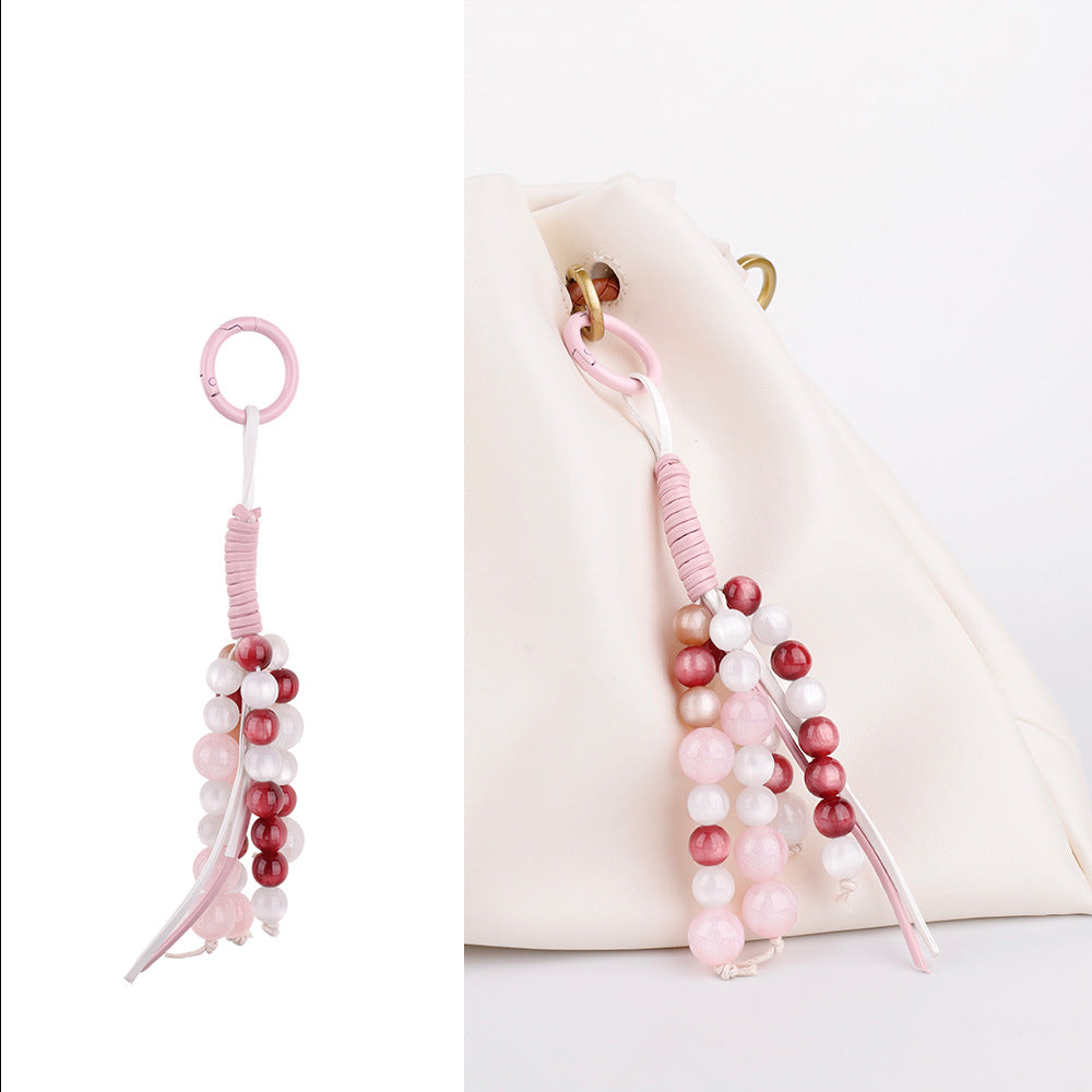 Small handwoven charm for keys, bags, or phones
