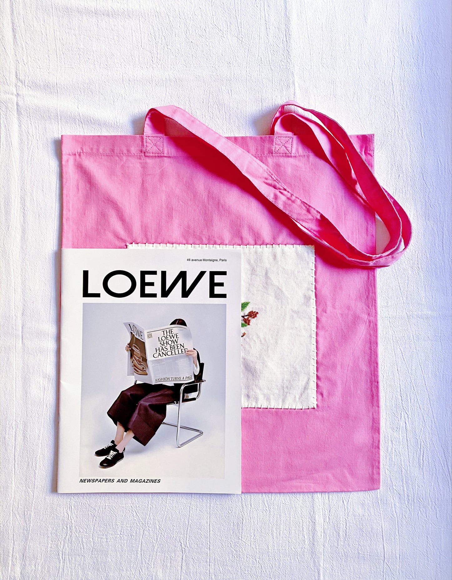 Pink shoulder bag featuring a decorative DIY-style flower design