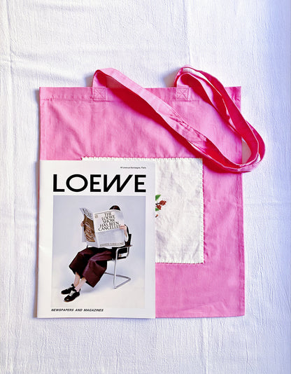 Pink shoulder bag featuring a decorative DIY-style flower design