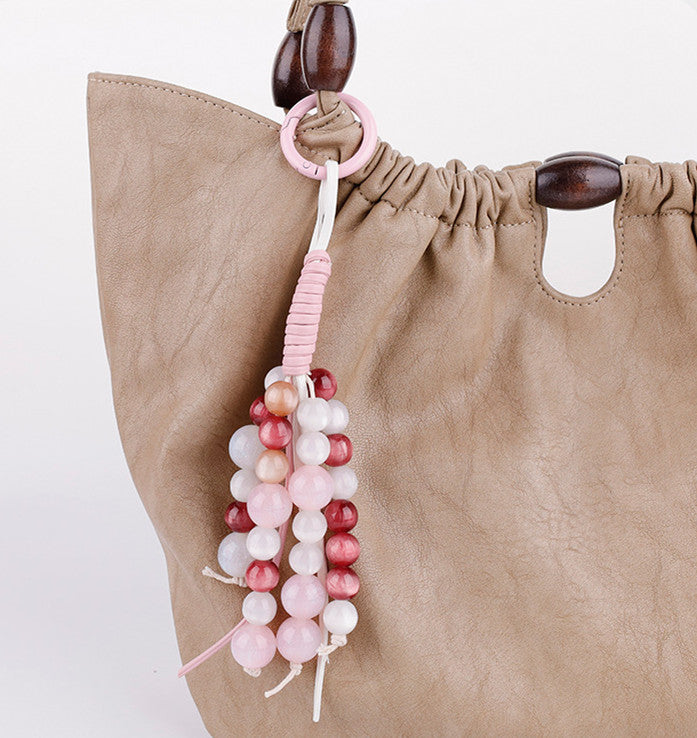 Handwoven pink jade beads styled as a bag accessory