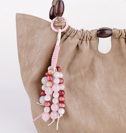 Handwoven pink jade beads styled as a bag accessory
