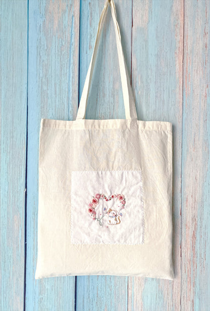 Rose and cat embroidered design providing a unique, handcrafted look accessory.