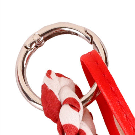 Red bow handbag accessory with a playful spotted pattern