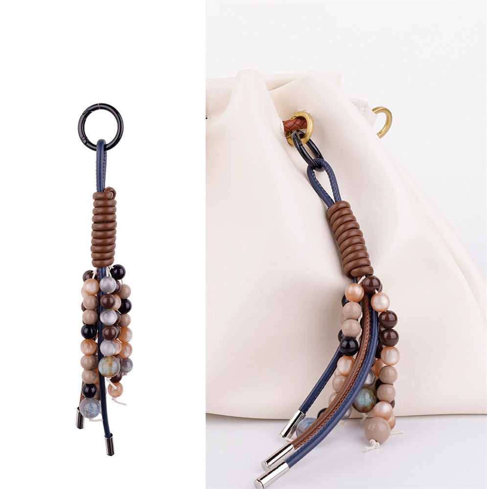 Elegant stone bead and leather tassel accessory styled for casual everyday outfit matching