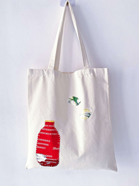 Person hands-free with a large tote over the shoulder while cycling in the city.