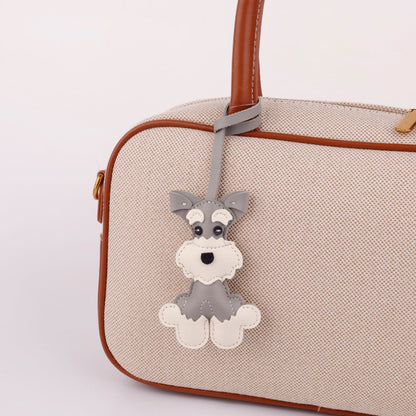 Playful cartoon dog accessory attached to a bag