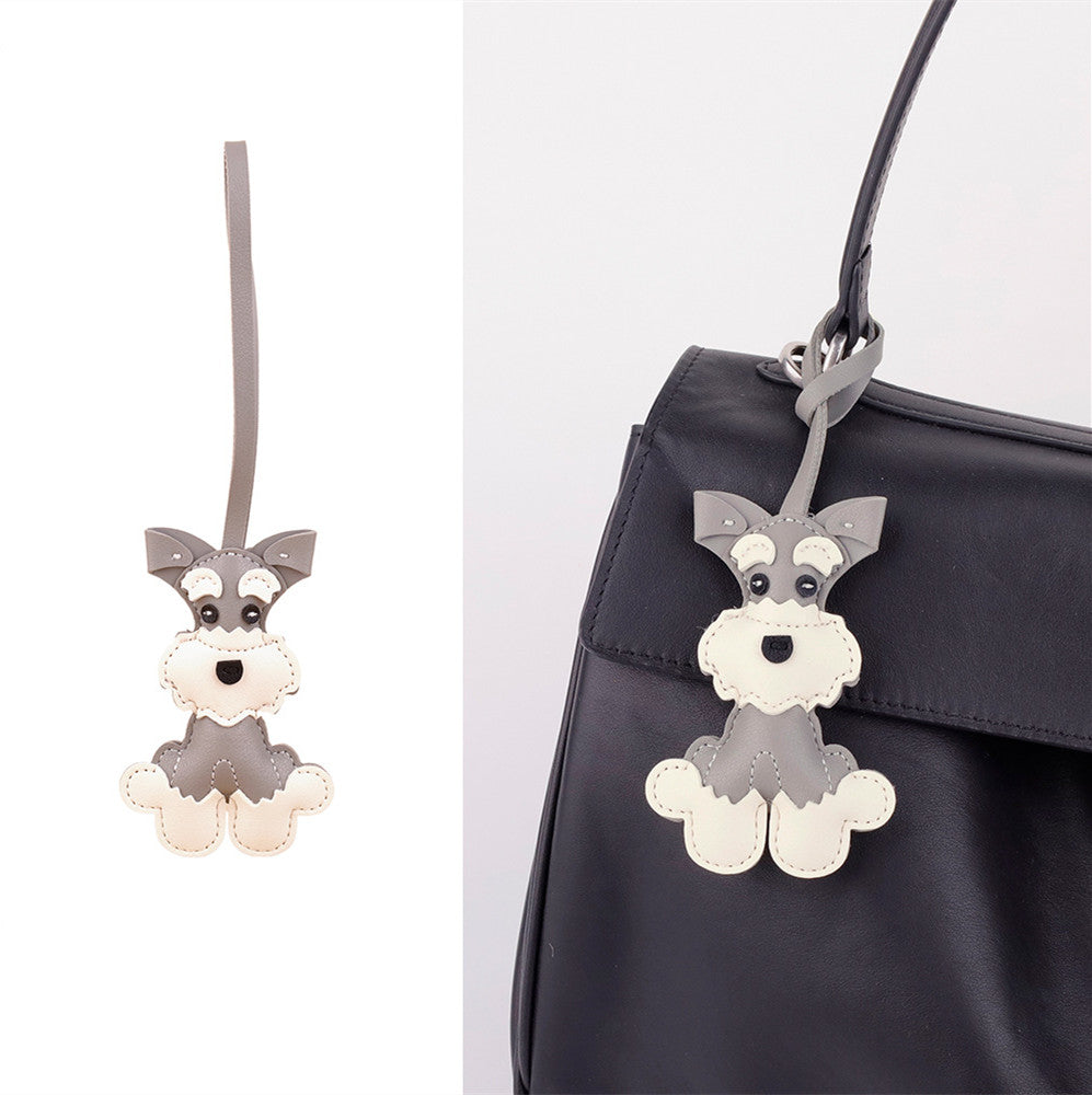 Three-dimensional cartoon dog clipped to a handbag