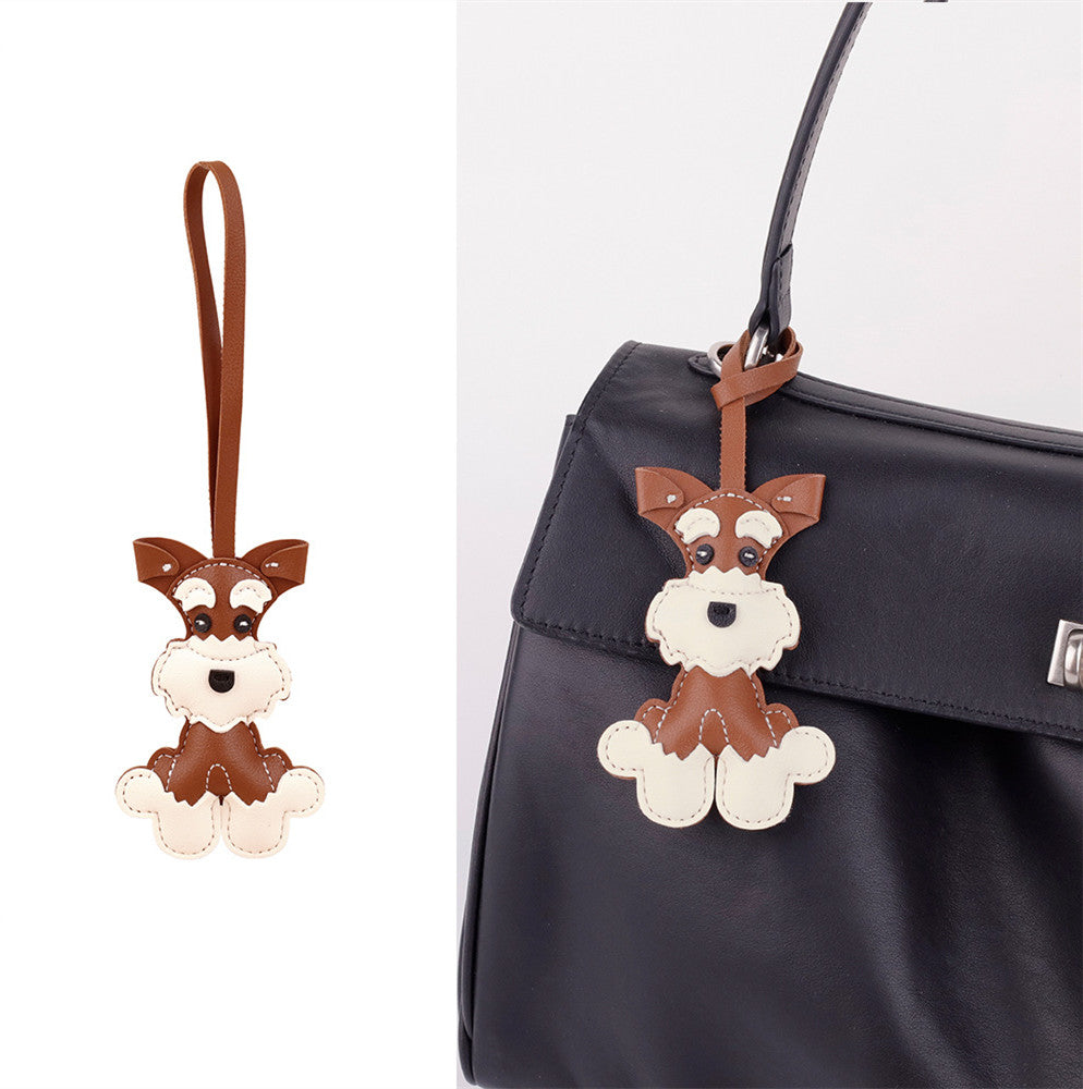 Handmade puppy ornament shown on a shoulder bag