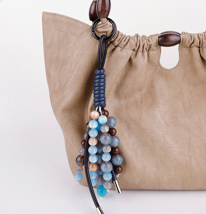 Handmade lavender gemstone purse charm used as a cute phone strap