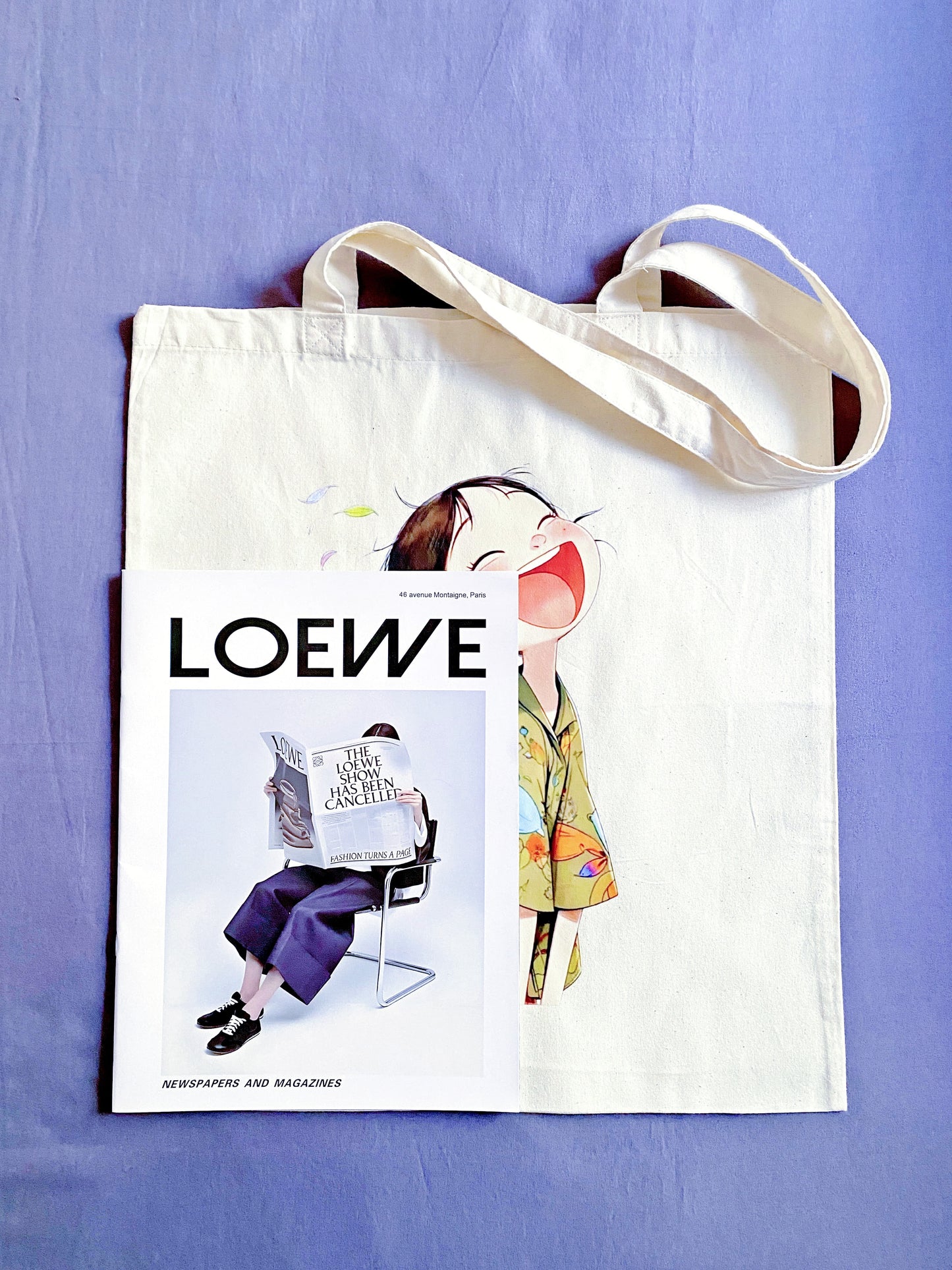 This eco-friendly cotton tote, featuring a whimsical hand-printed design of a laughing girl, is a meaningful gift that radiates positivity.