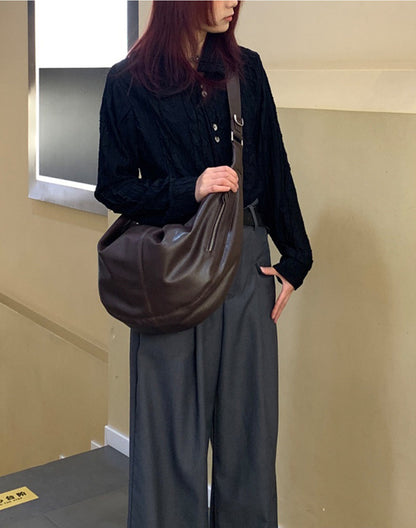 Large shoulder bag with curved shape for everyday essentials