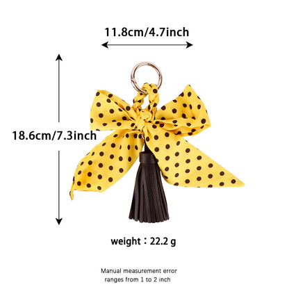 Vintage-inspired handbag accessory with tassel