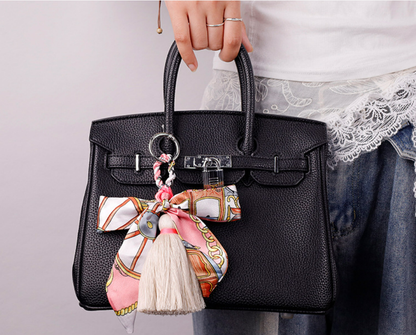 Colorful silk scarf tassel keychain clipped onto a set of car keys