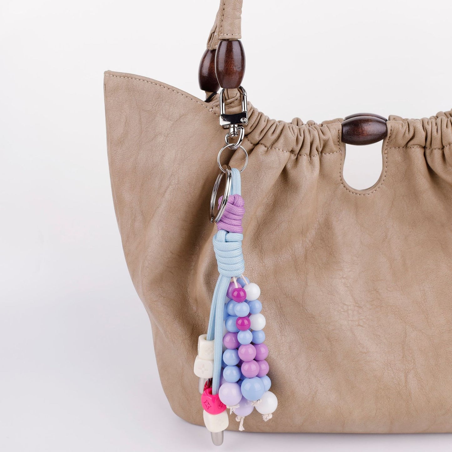 Soft purple crystal beaded bag charm styled on a everyday handbag