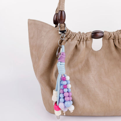 Soft purple crystal beaded bag charm styled on a everyday handbag
