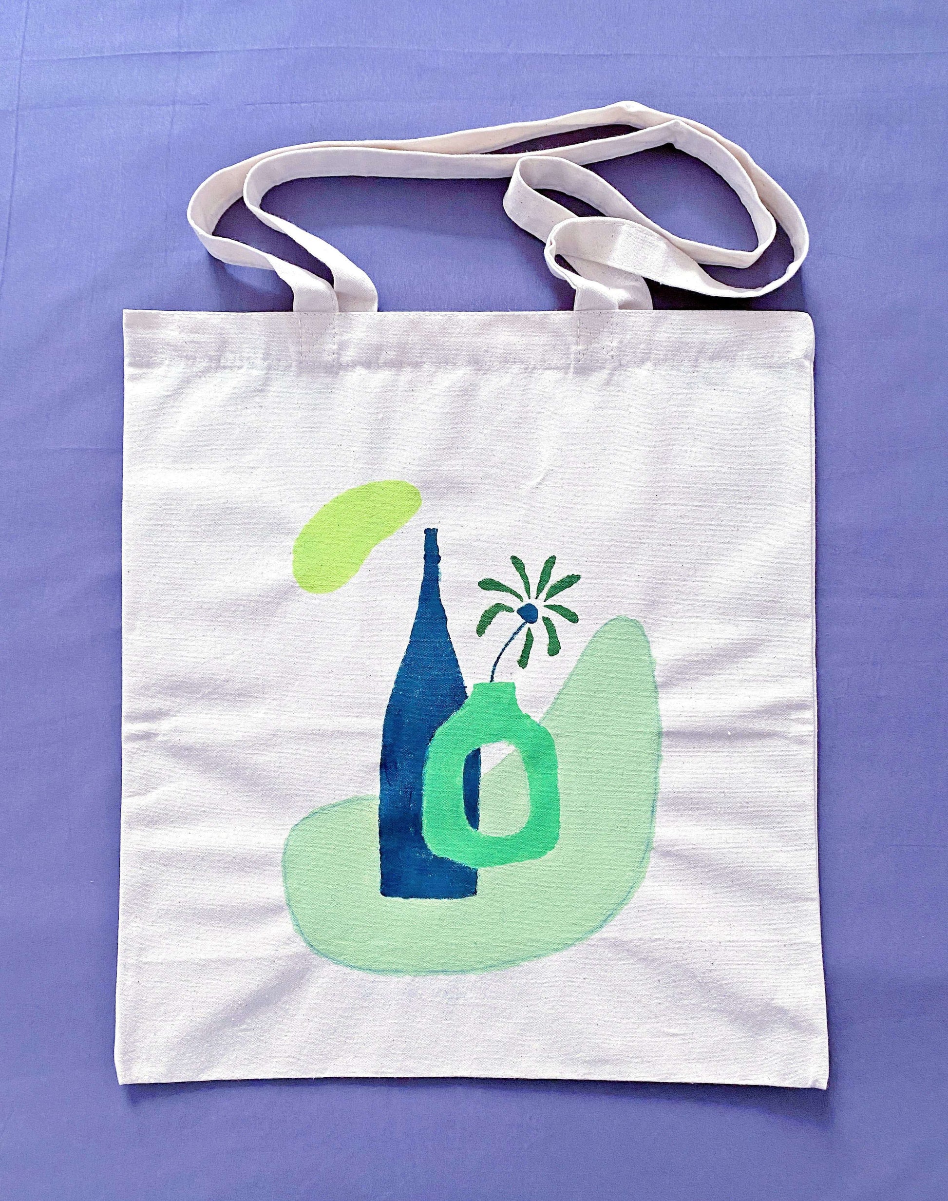 A relaxed oversized canvas tote resting on a wooden bench