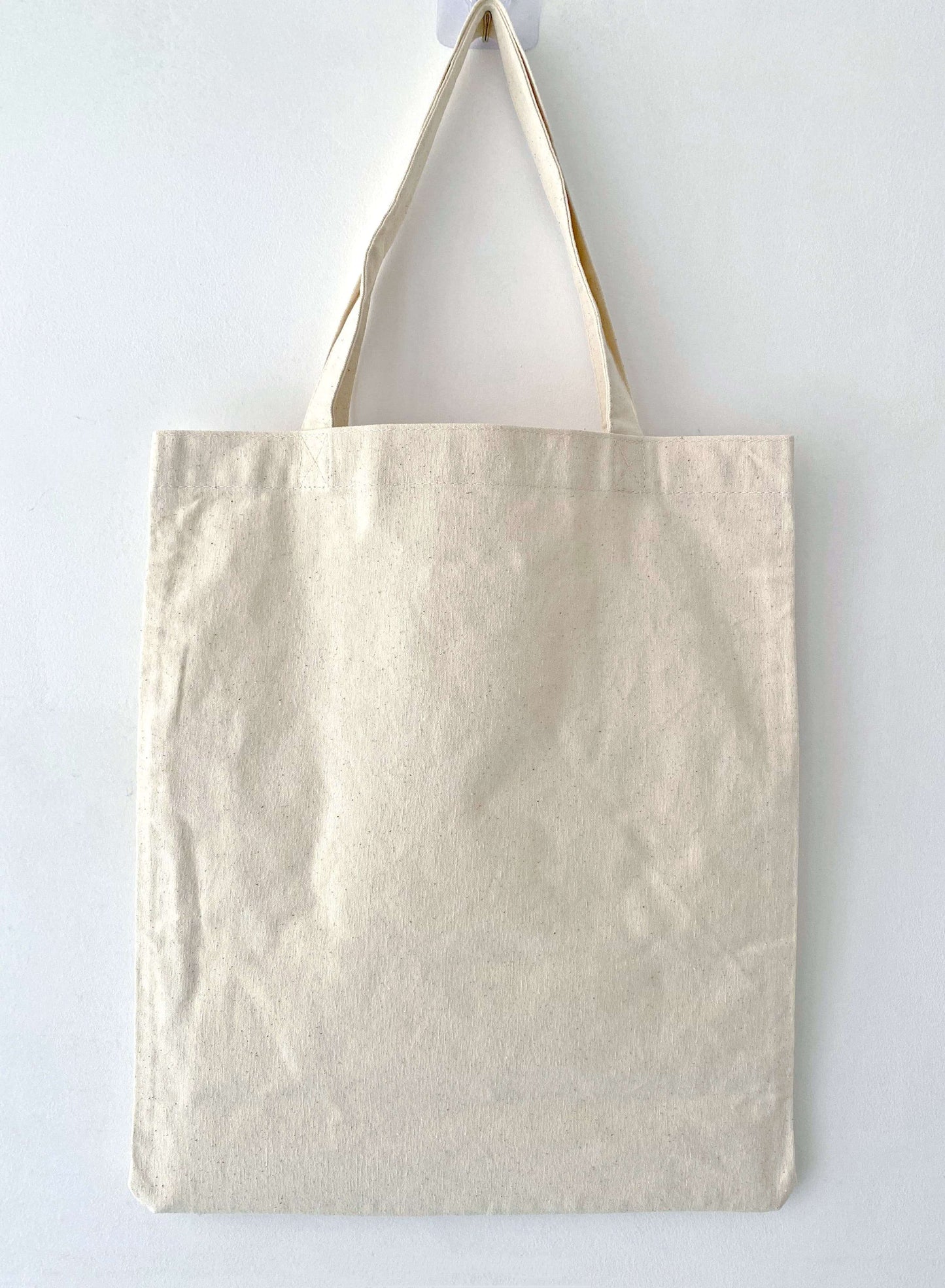 We designed this large canvas bag to handle heavy loads for years, decorated with embroidery that ages gracefully alongside your personal story.