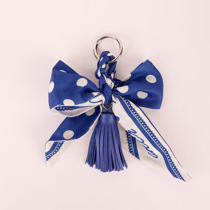 Scarf-inspired bow accessory with tassel