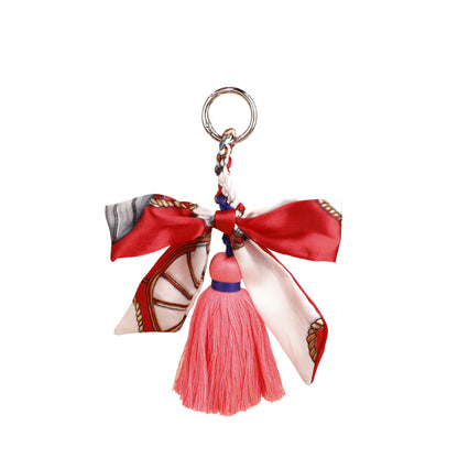 Patterned ribbon keychain clip attached to a travel bag handle