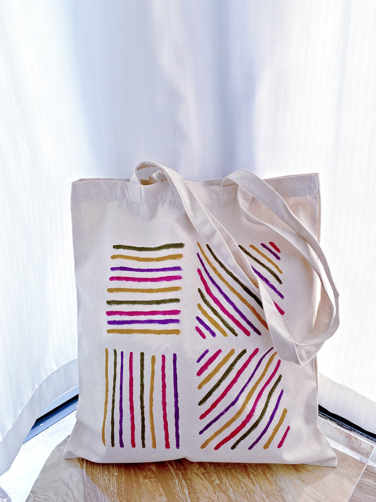 A large hand-painted bag being used for a quick grocery run at a local shop.