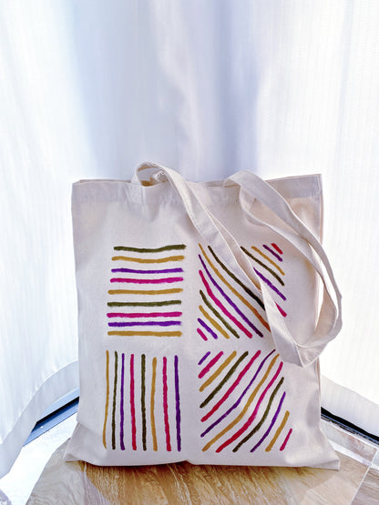 A large hand-painted bag being used for a quick grocery run at a local shop.