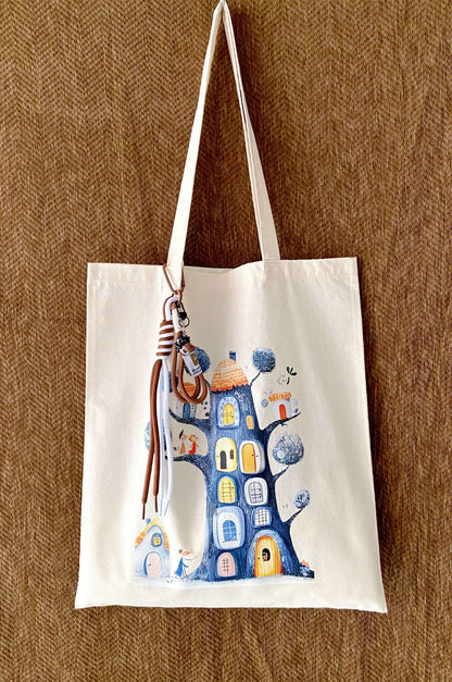 Close-up of a slouchy cream cotton tote showing hand-stamped leaf patterns.