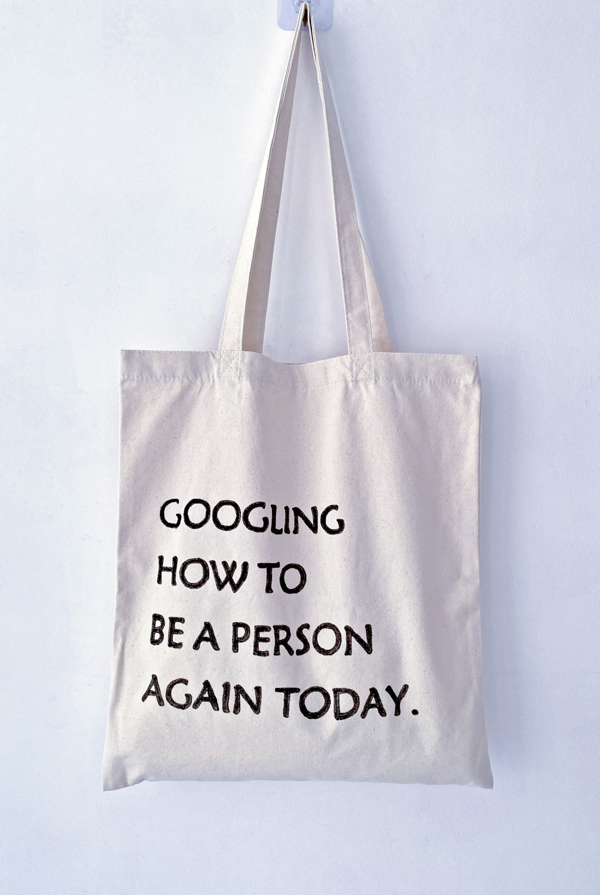 soft slouchy canvas tote bag with unique hand-drawn words, casual street style
