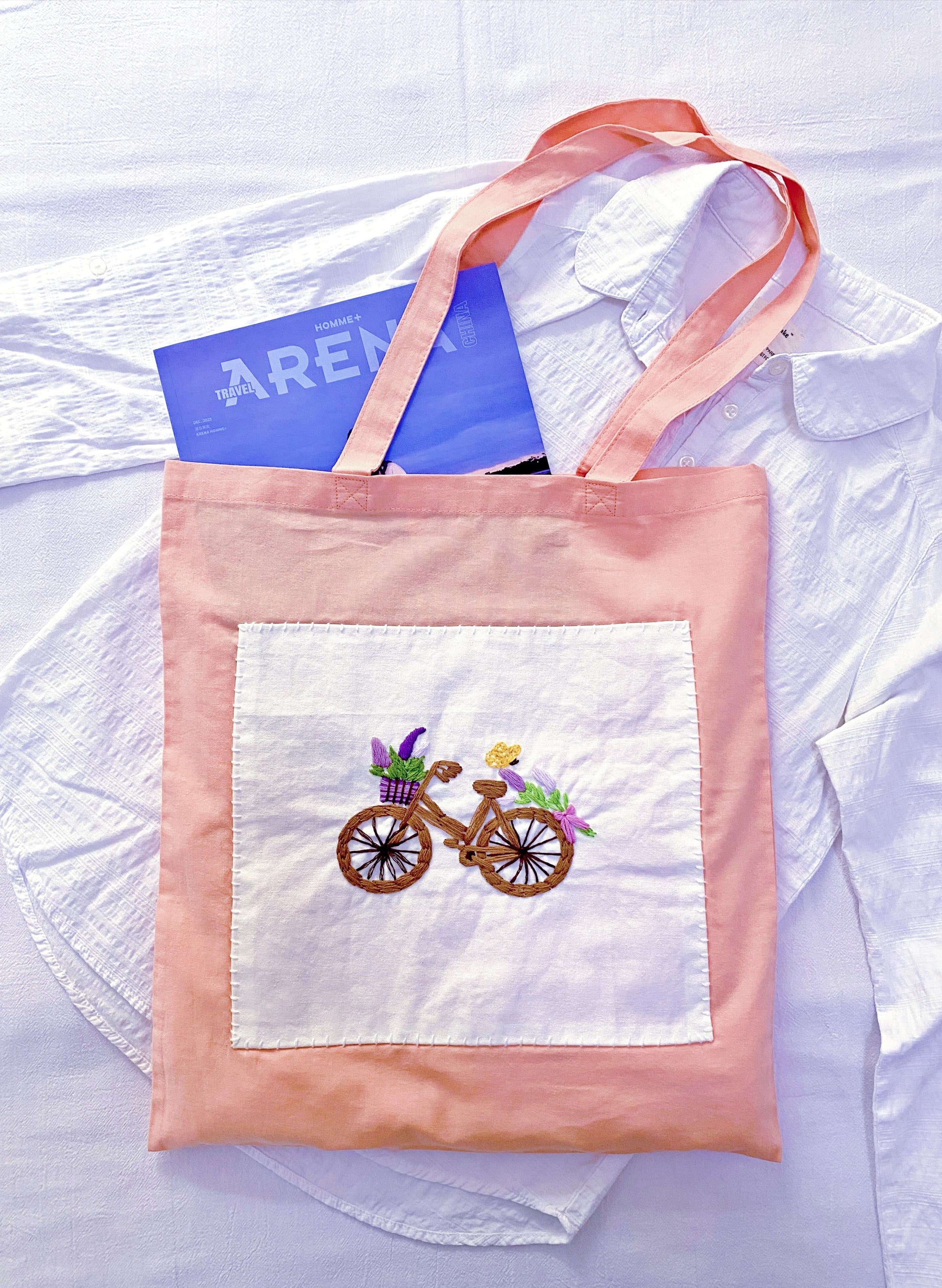 Person carrying a slouchy cream cotton tote during a slow weekend morning.