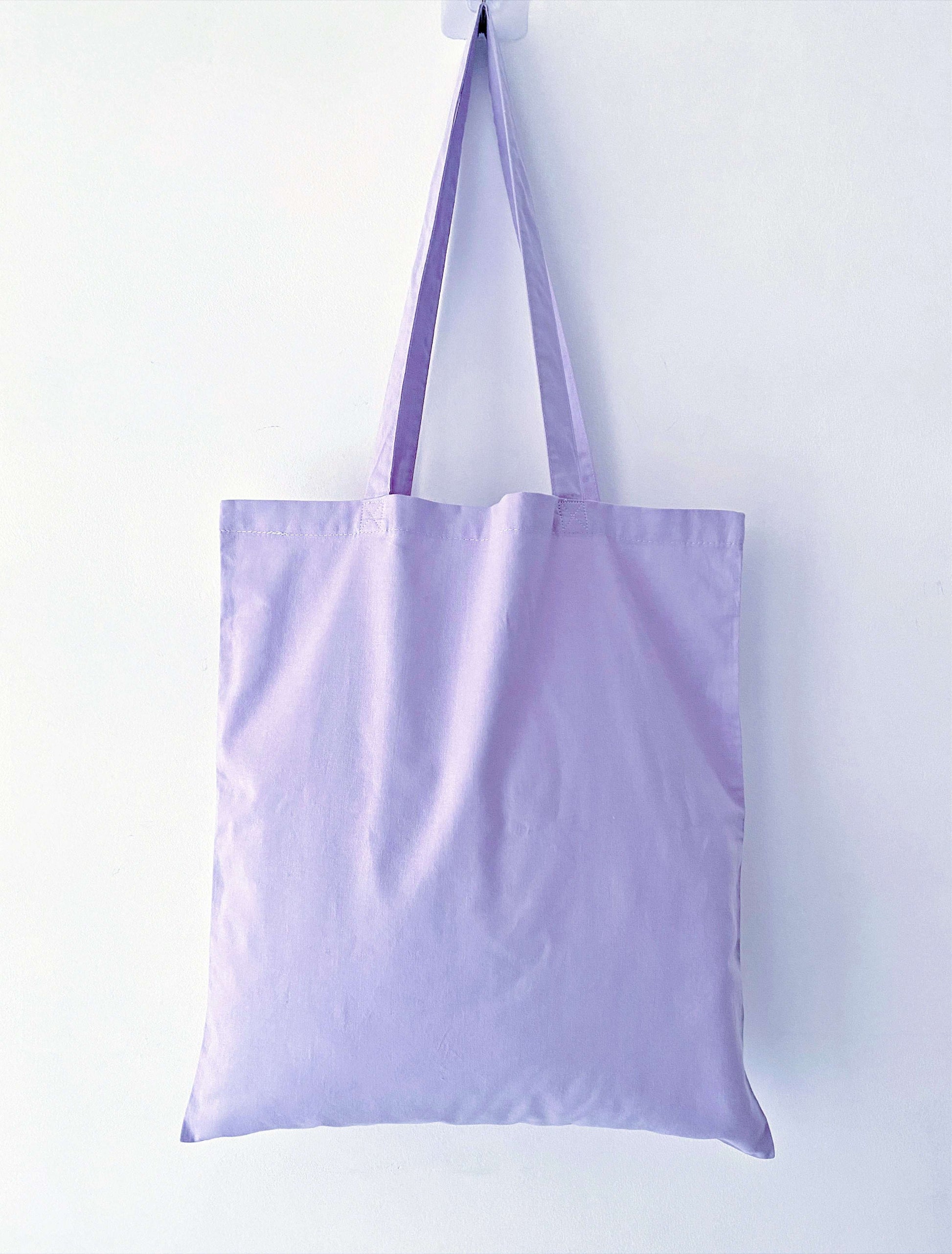 Sunlit purple tote with botanical embroidery, bringing a calming nature aesthetic to daily city life.