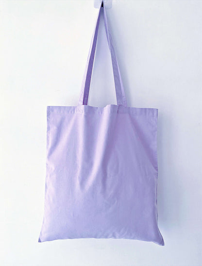 Sunlit purple tote with botanical embroidery, bringing a calming nature aesthetic to daily city life.