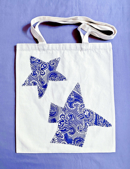 Hand-stitched patchwork tote bag made from eco-friendly canvas, the perfect gift for someone who loves unique, sustainable fashion.