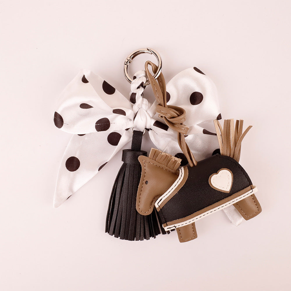 Playful handbag charm with black white polka dots