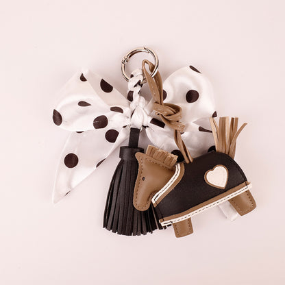 Playful handbag charm with black white polka dots