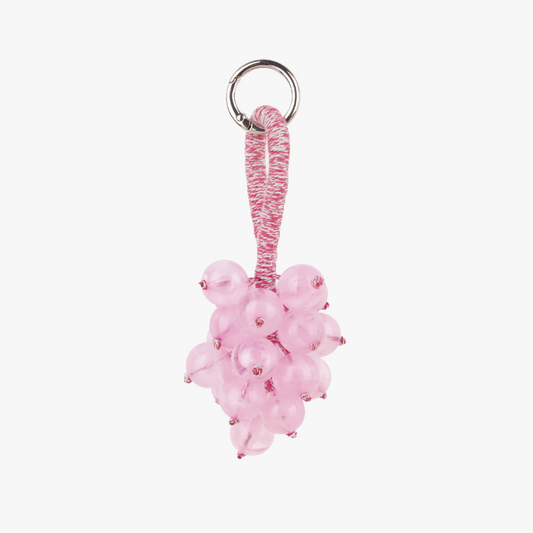 Textured fruit bunch decoration attached to a bag handle