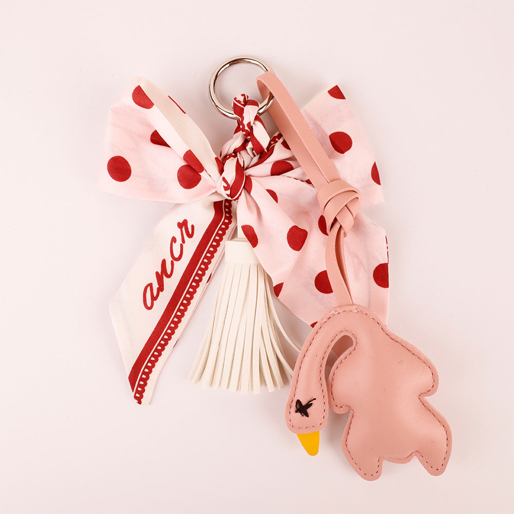 Polka dot bow charm styled with a shoulder bag