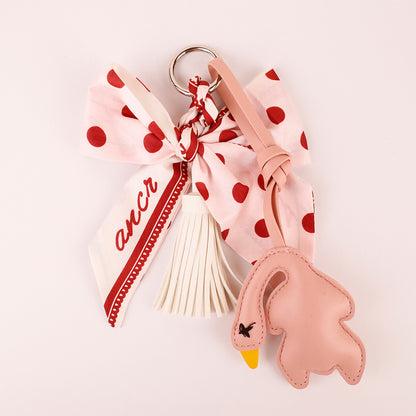 Polka dot bow charm styled with a shoulder bag