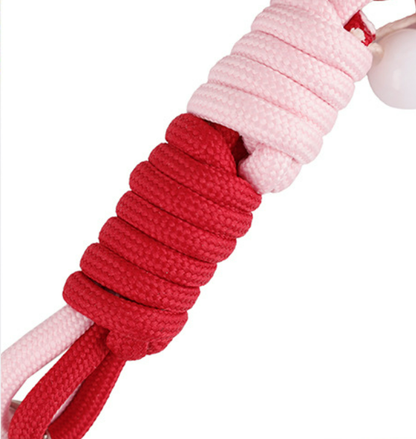 Beaded accessory hanging from the side of a purse