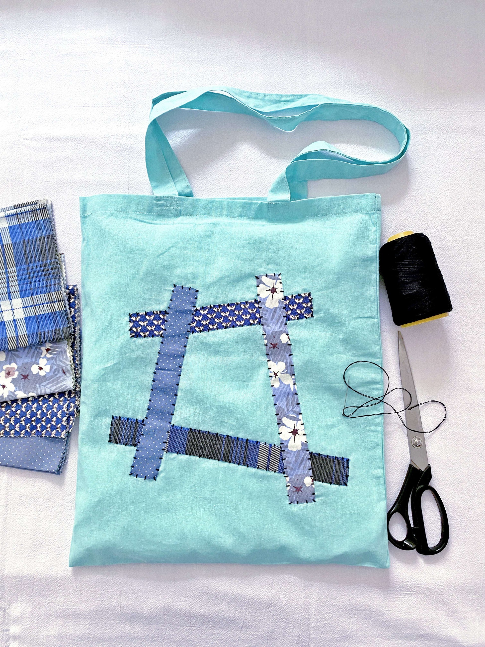 Soft oversized cotton tote bag with hand-stitched patchwork detail for daily errands