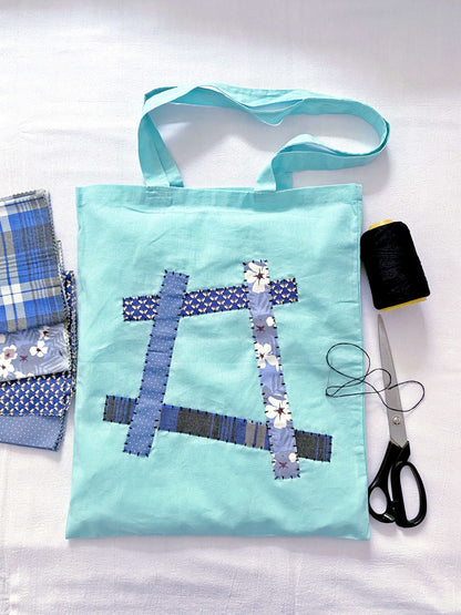 Soft oversized cotton tote bag with hand-stitched patchwork detail for daily errands