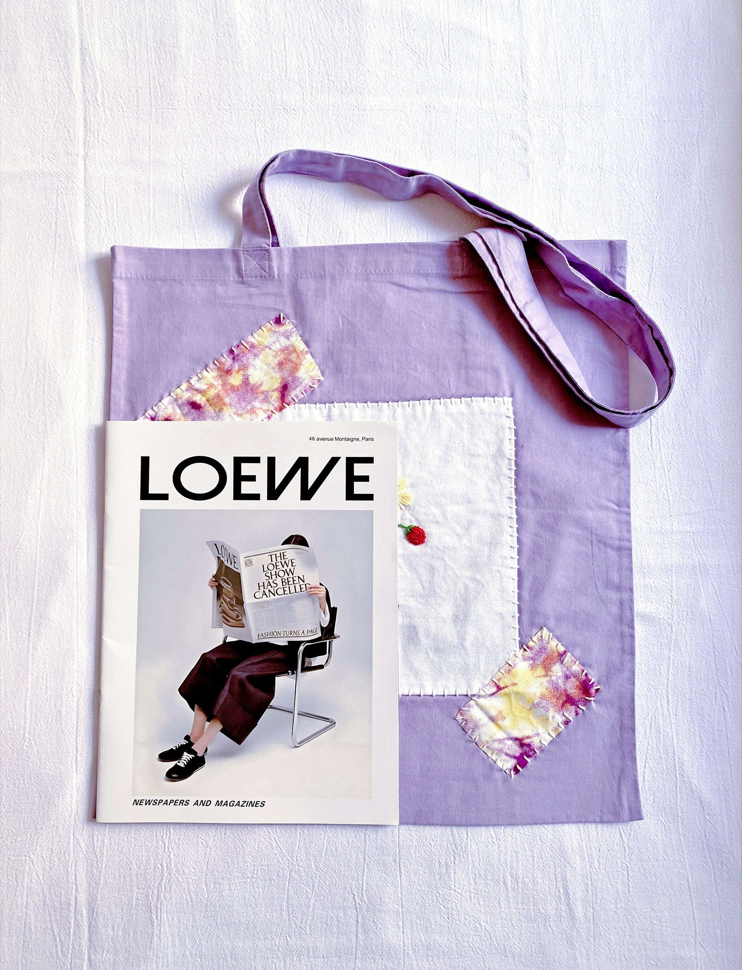 Unique floral embroidered bag on café chair, an artistic accessory that sparks conversation about handcrafted design.